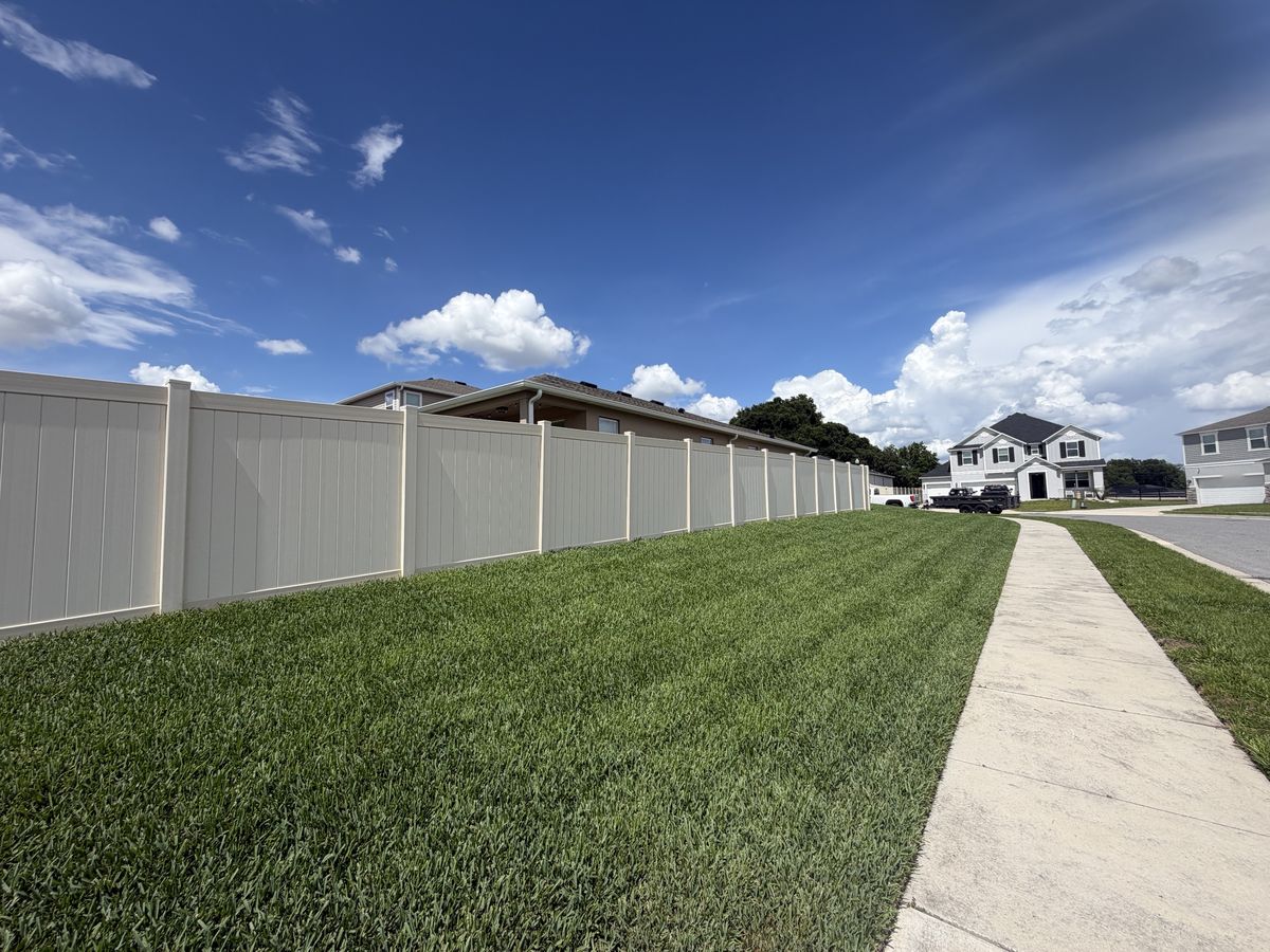 ProVista St. Augustine side lawn along a vinyl fence and sidewalk in Apopka FL